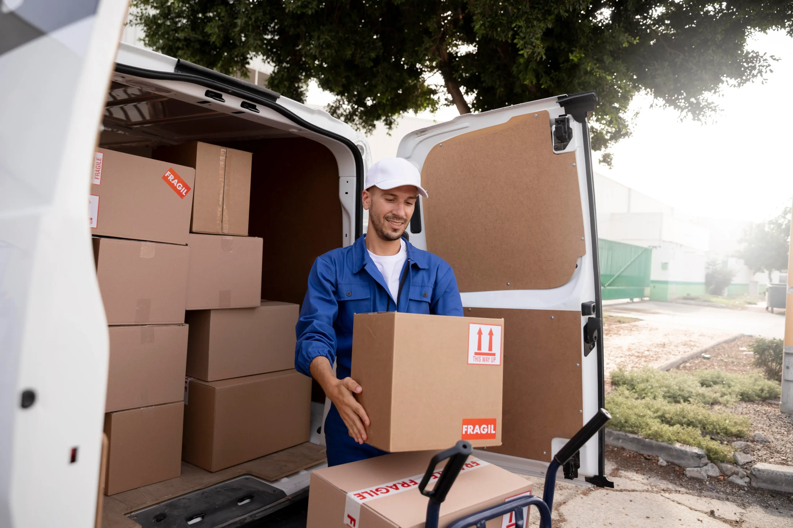 Mover smiling while unloading a fragile box – About Moving delivering with a smile